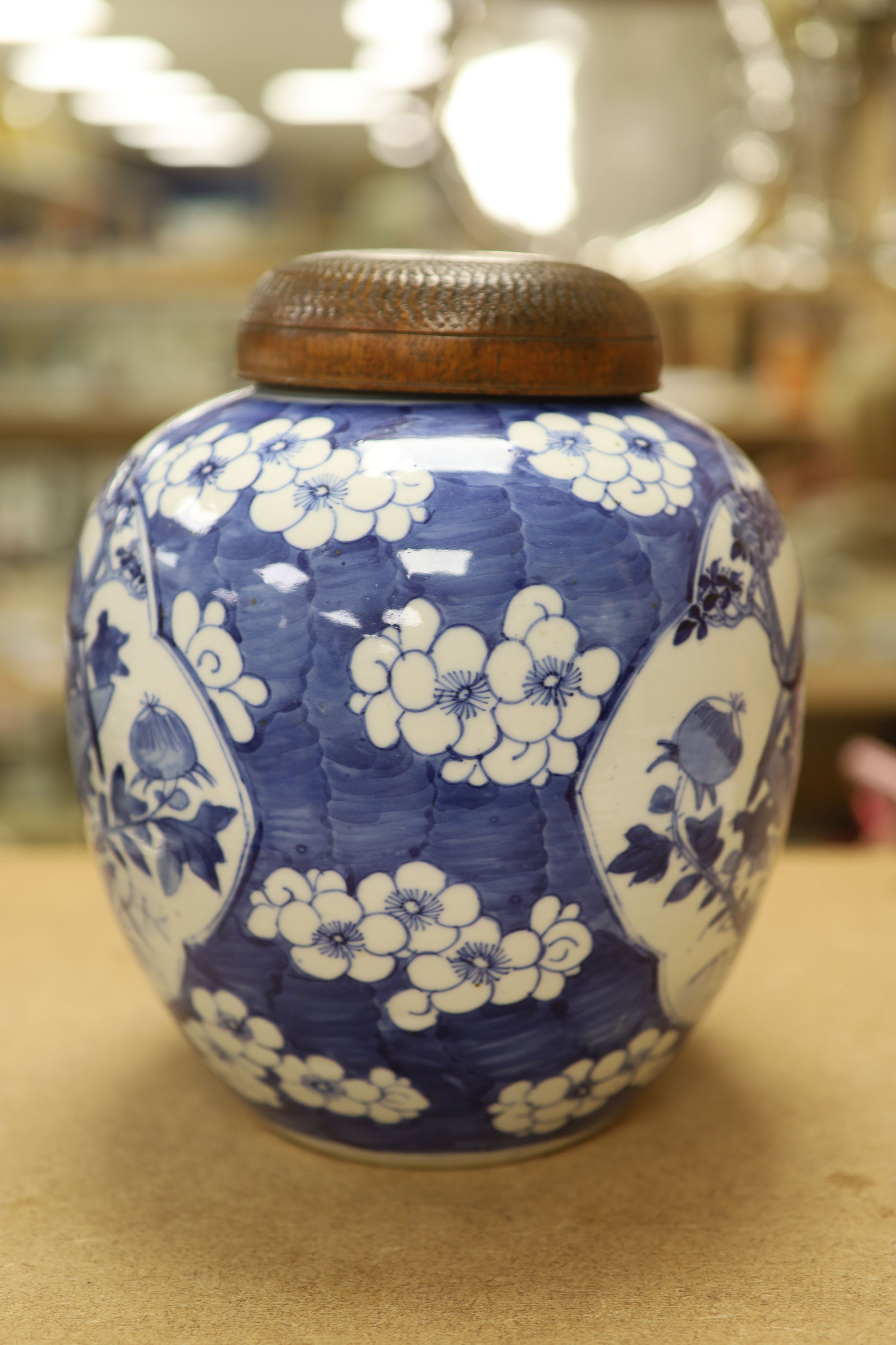 A late 19th / early 20th century Chinese blue and white jar, with wooden cover, height 25cm